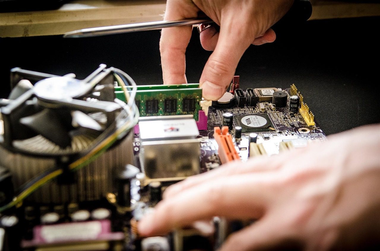 Technician working on computer motherboard